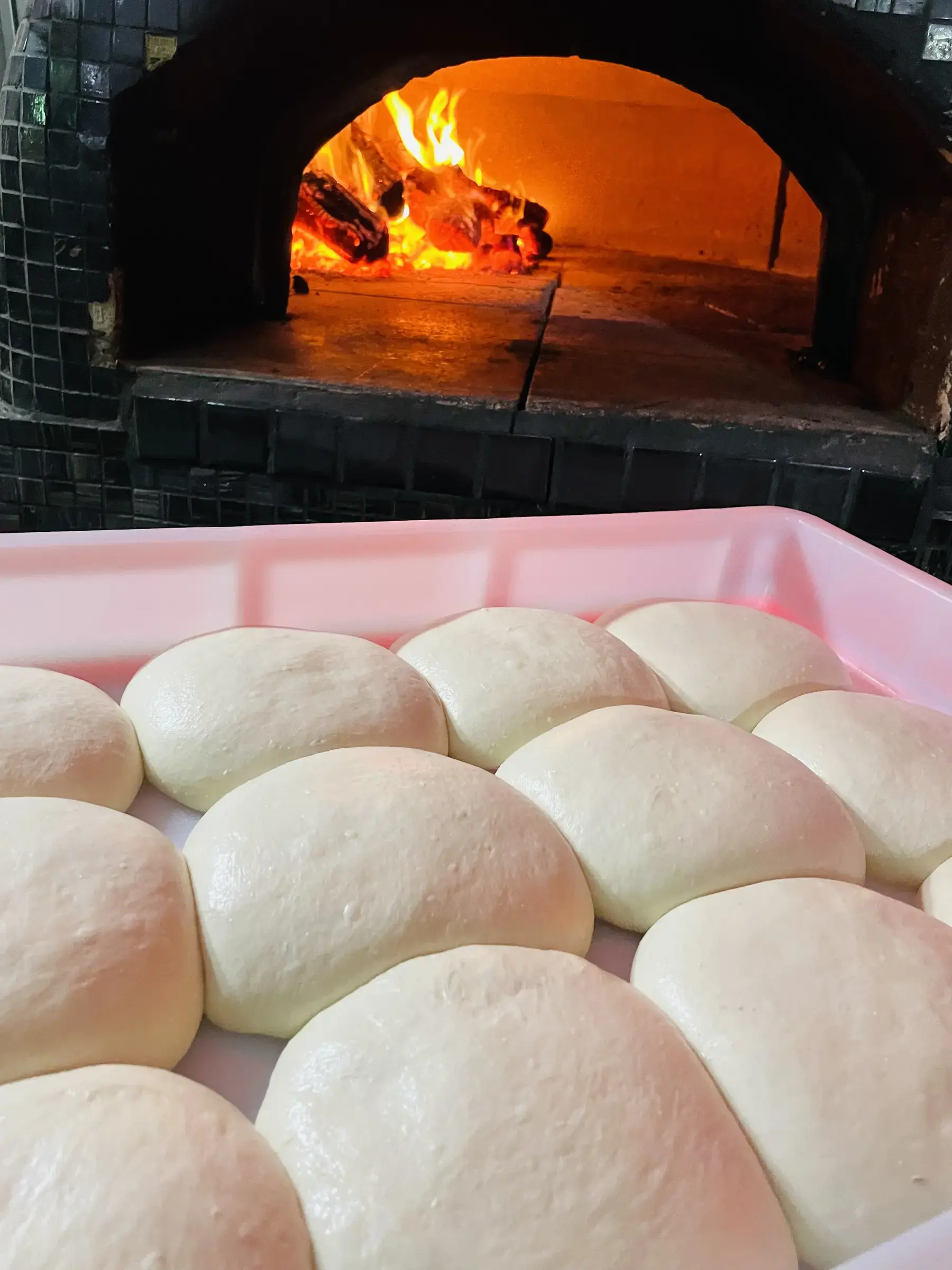 Hand-stretching 48-hour fermented dough